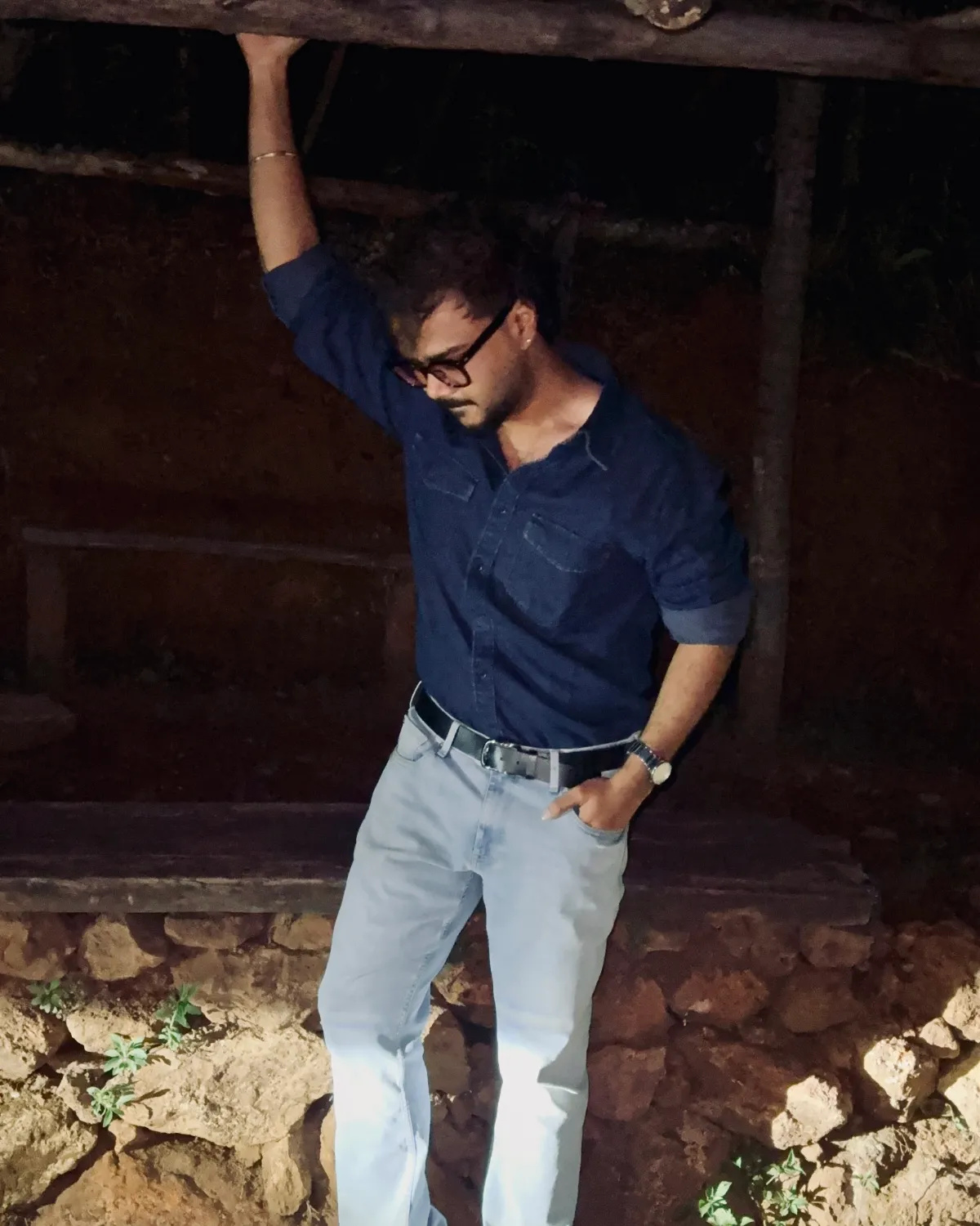 Havish Reddy, founder of Preem Media, leaning on a timber beam at night